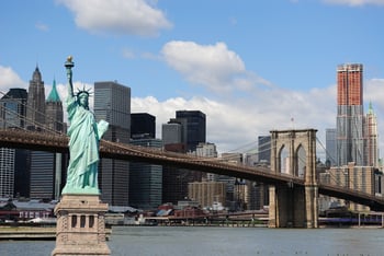 The landmark Statue of Liberty against the impressive New York City skyline.